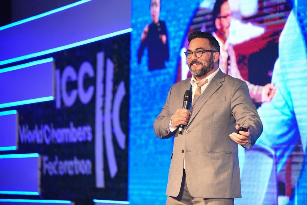 Dr. Jeremy Roberts speaking on stage in Bogota, Colombia