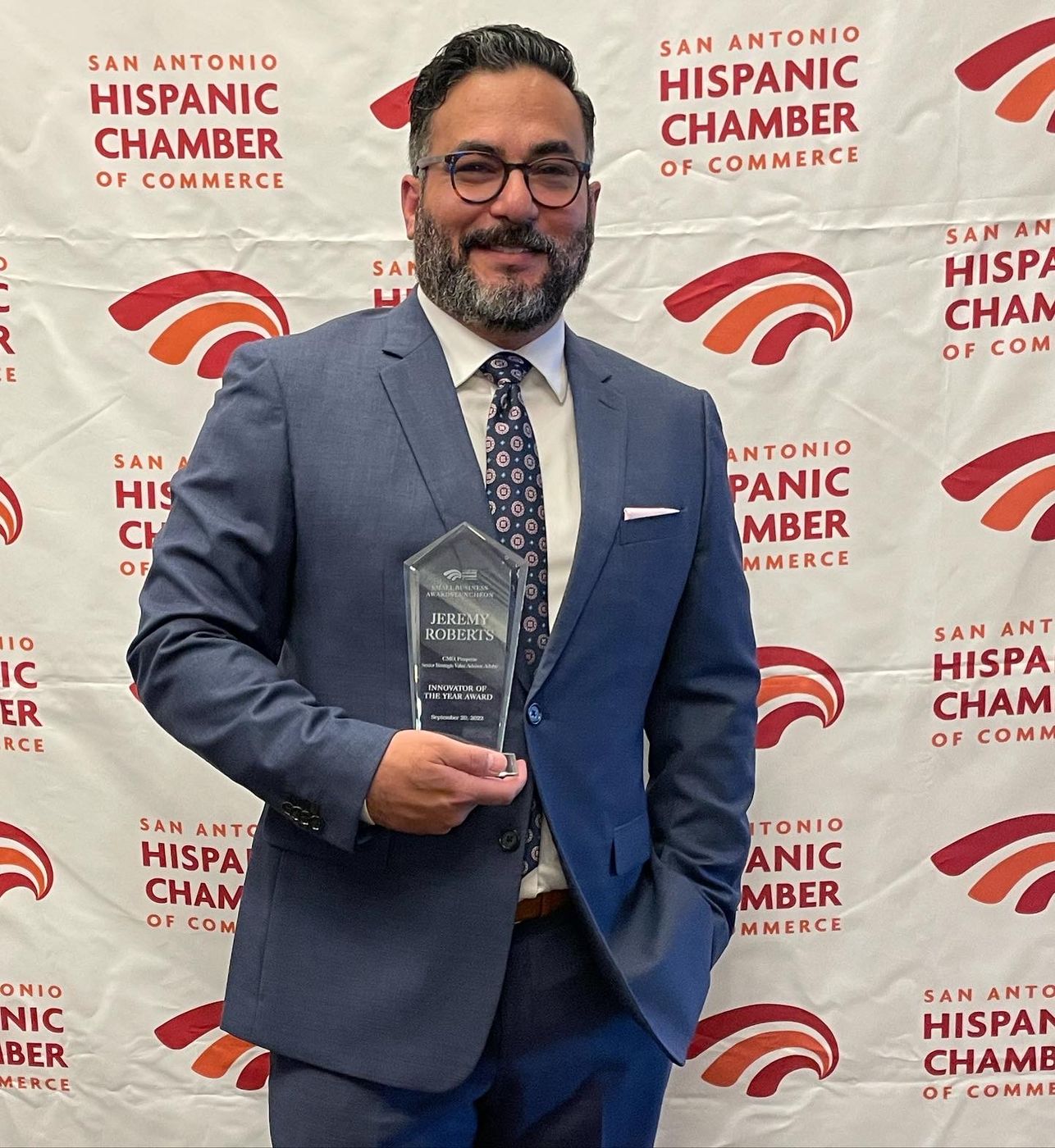 Dr. Jeremy Roberts holding the Innovator of the Year award from the San Antonio Hispanic Chamber of Commerce